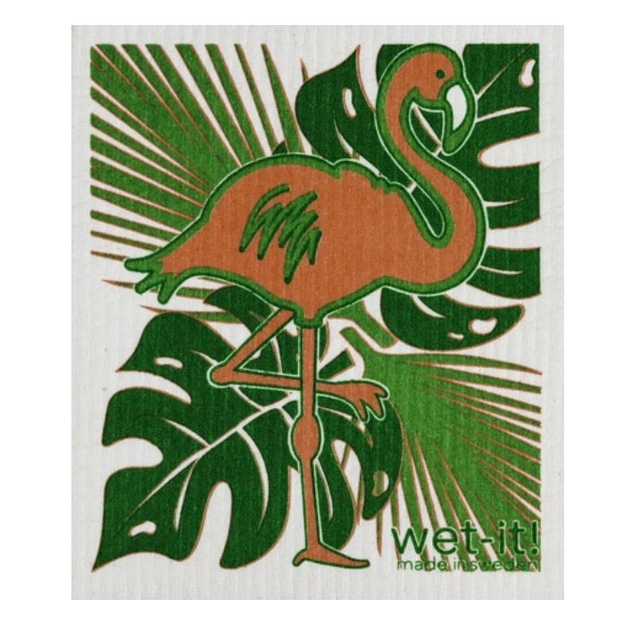 ivory colored rectangle shaped scrubbing pad with a large pink flamingo standing over a green palm leaf background  screen printed on it