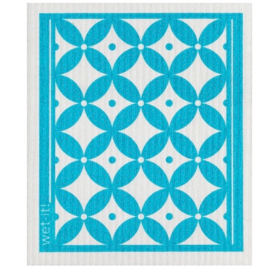 ivory colored rectangle shaped scrubbing pad with a turquoise pattern screen printed on it