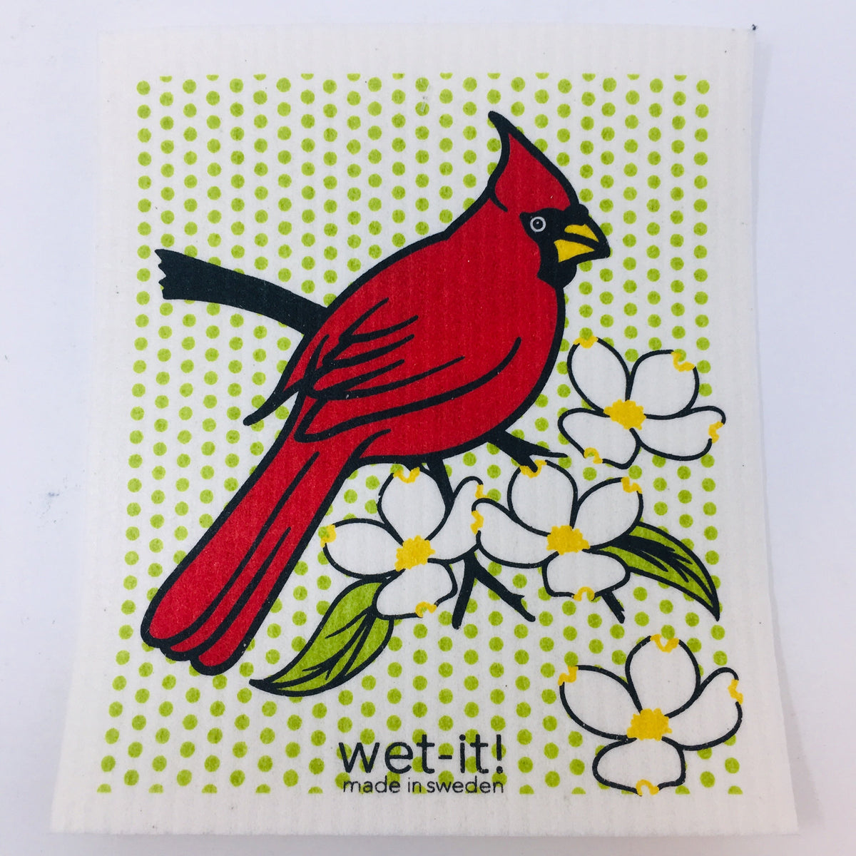 ivory colored rectangle shaped scrubbing pad with a large red cardinal on an apple blossom branch over a background of tiny lime green colored dots  screen printed on it