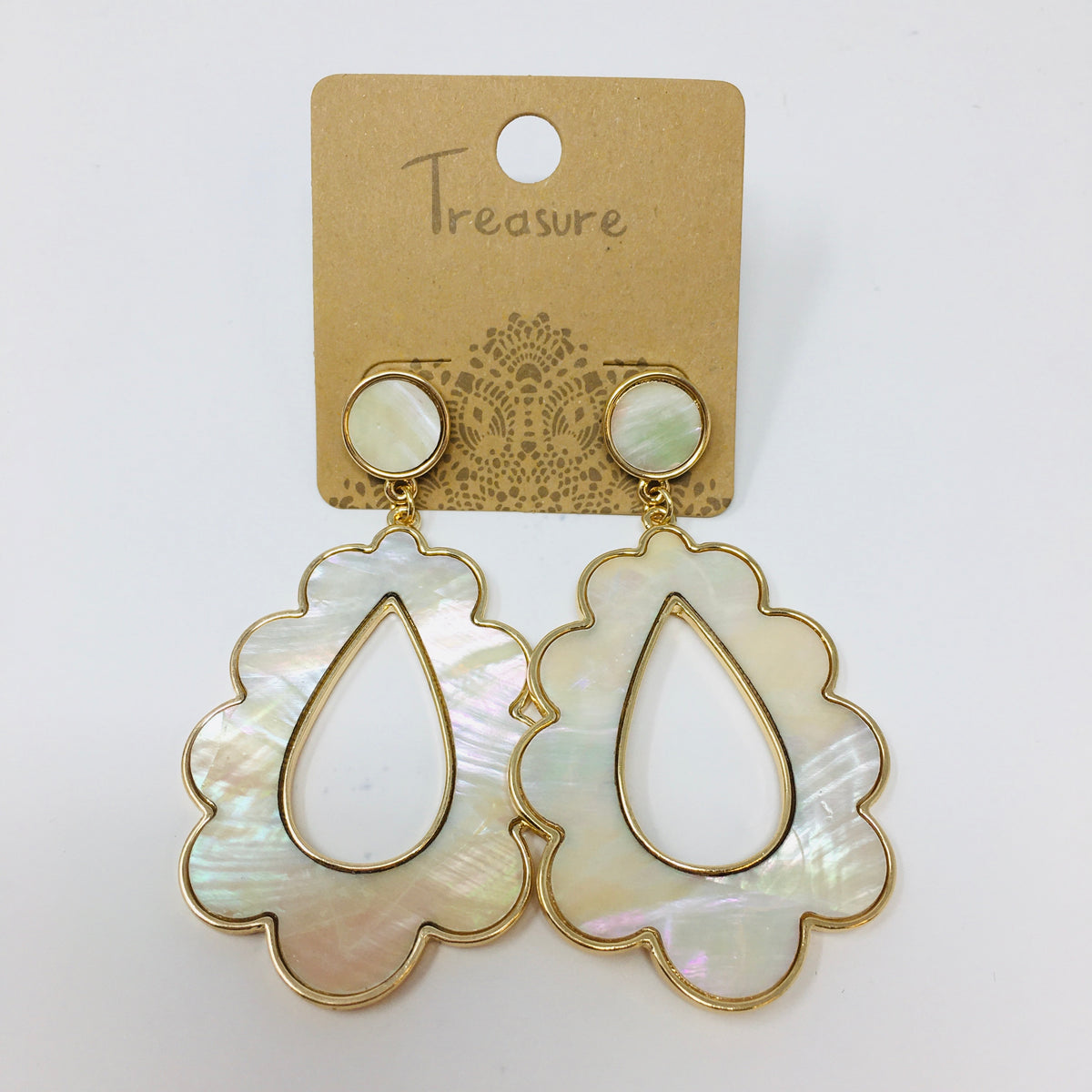 Scalloped teardrop shaped gold tone earrings with mother of pearl inserts shown on a white background