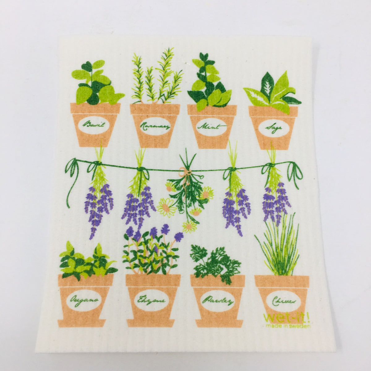 ivory colored rectangle shaped scrubbing pad with a top row of 4 clay pots of green herb plants, a middle row of lavender and daisies hanging on a line and a bottom row of 4 clay pots with green herbs in them screen printed on it