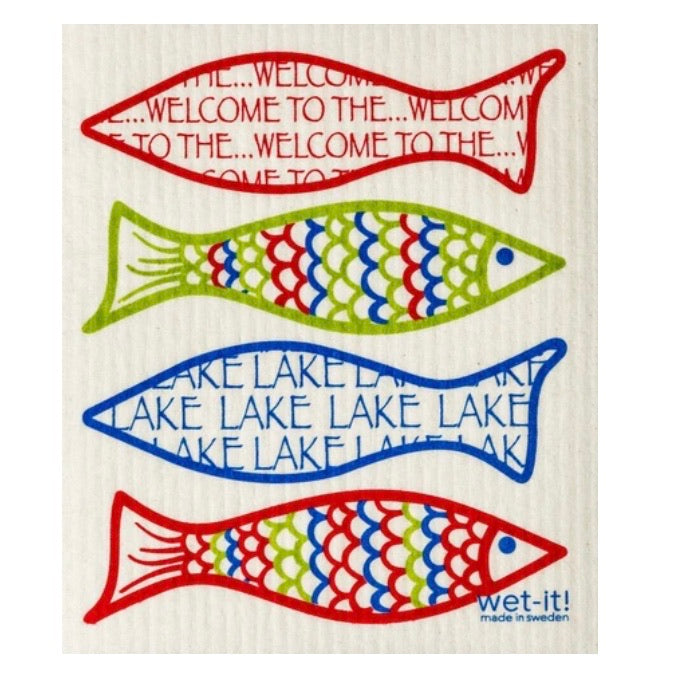 ivory colored rectangle shaped scrubbing pad with 4 large brightly colored artsy fish in red, lime green and blue witht he message &quot;welcome to the lake&quot; printed inside the fish outline screen printed on it