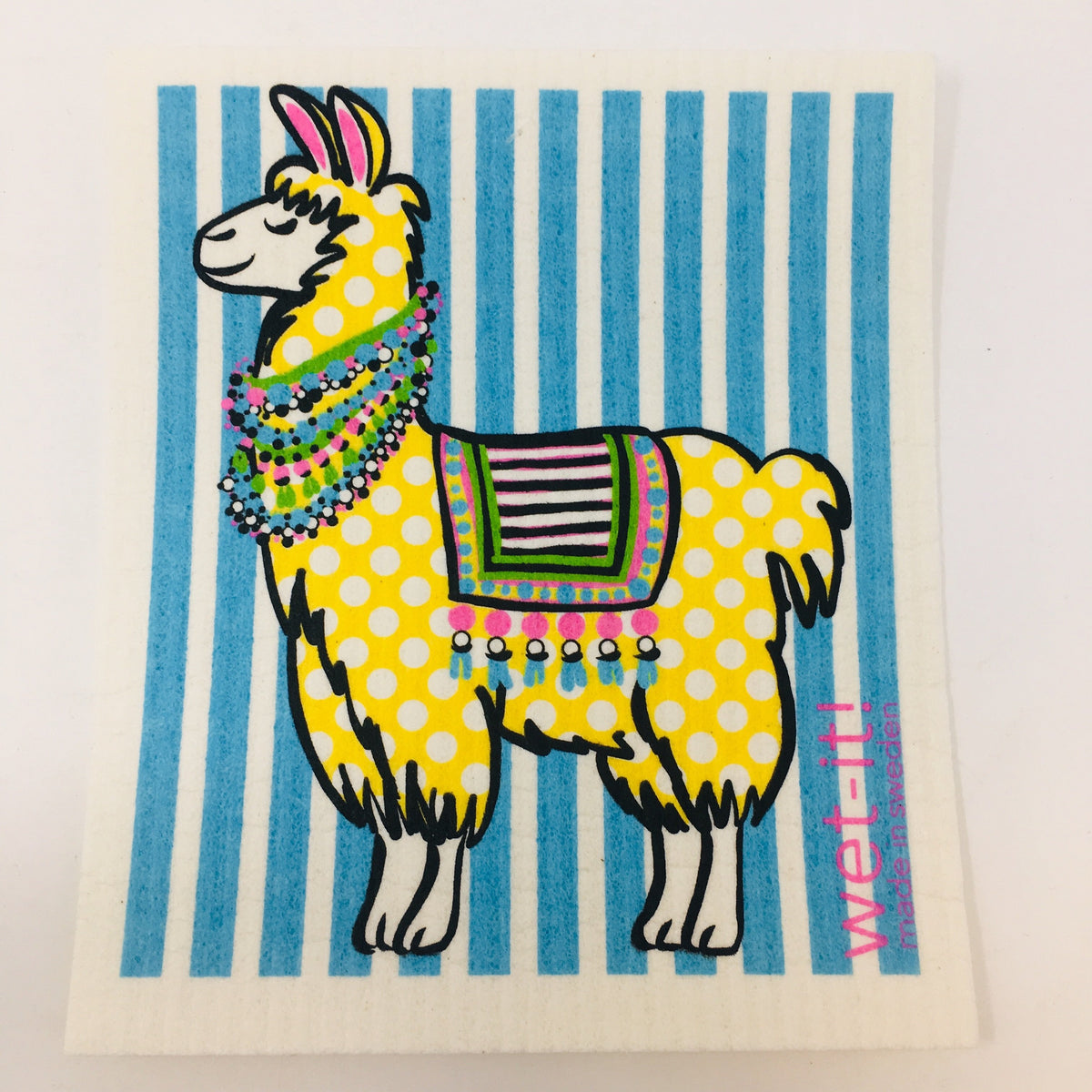 ivory colored rectangle shaped scrubbing pad with a bright colored yellow polka dotted llama on a blue striped background screen printed on it