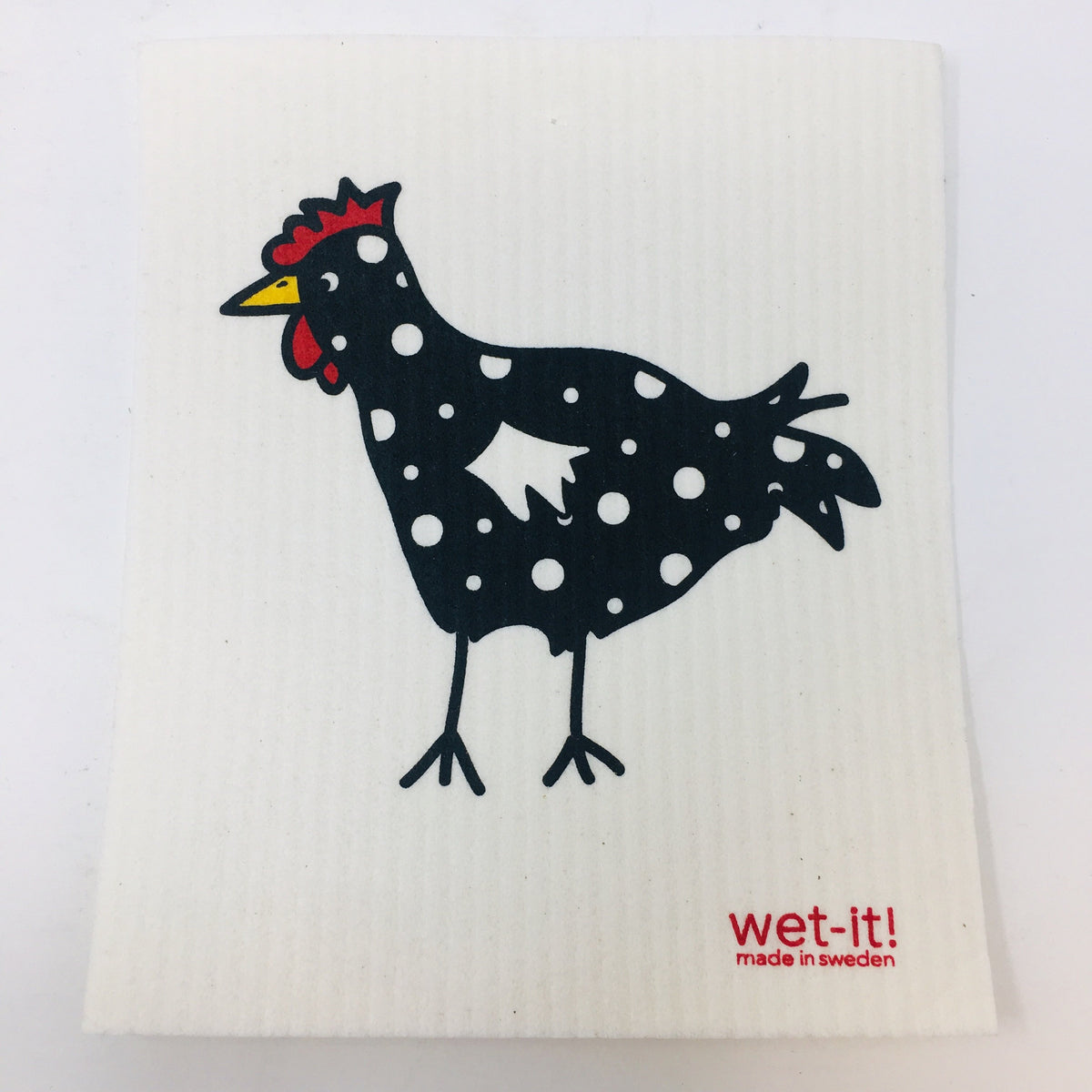 ivory colored rectangle shaped scrubbing pad with a large black and white polka dotted chicken screen printed on it