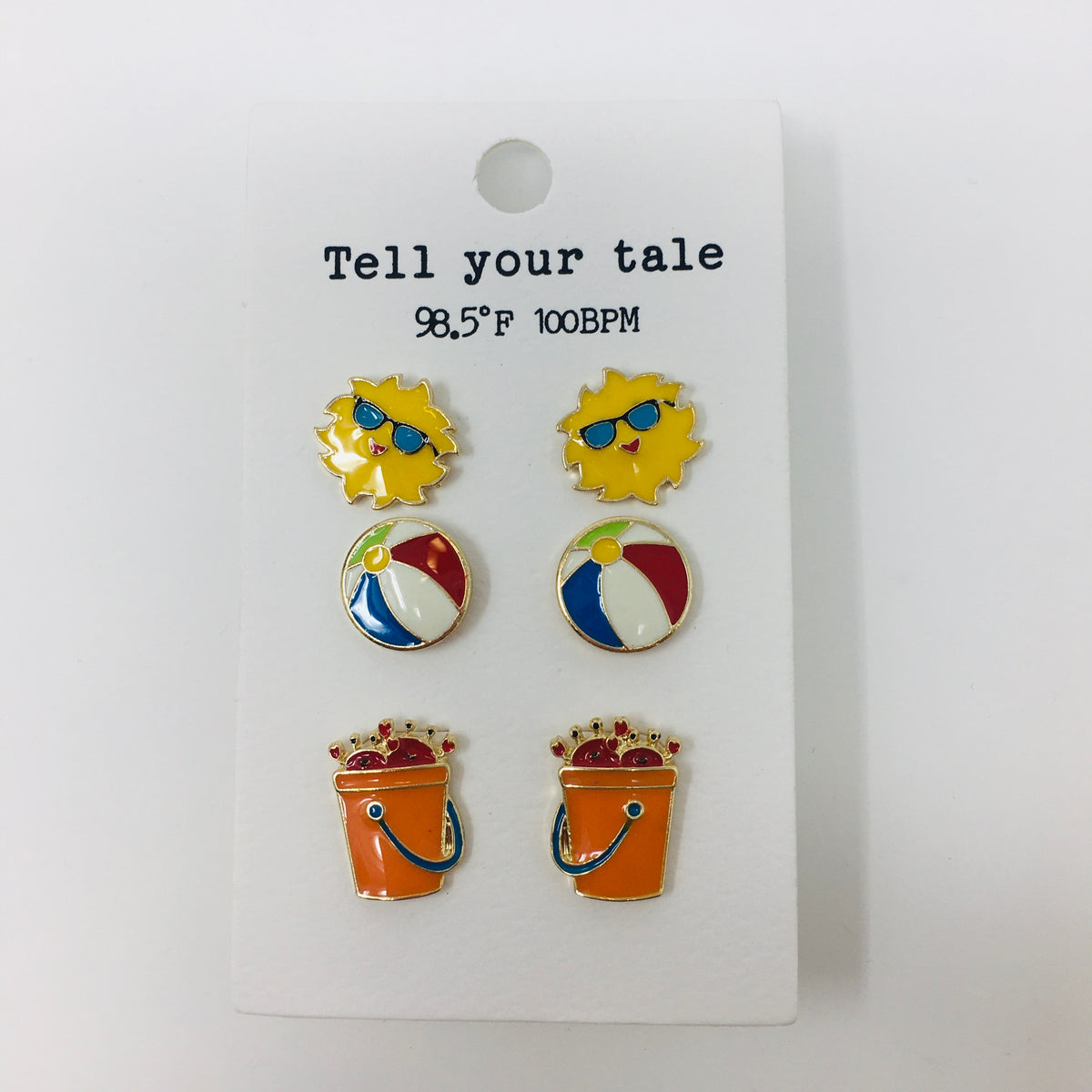 Set of 3 enamel colored post earrings on an ivory backer card showing yellow sunshine, multi colored beach balls, and orange sand buckets with red crabs sticking out of the top.