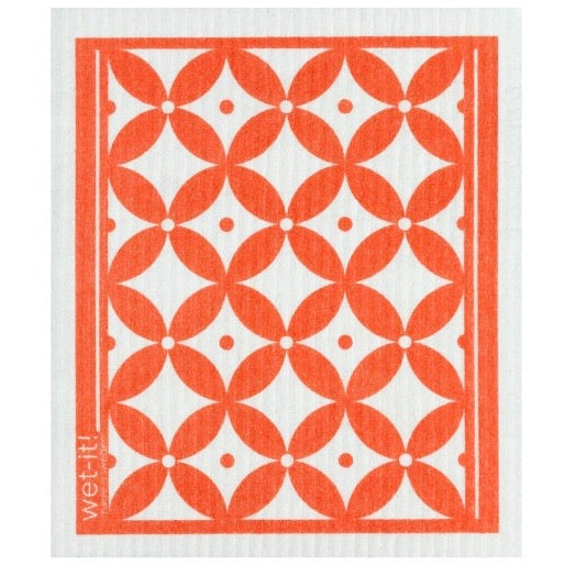 ivory colored rectangle shaped scrubbing pad with a coral colored pattern screen printed on it