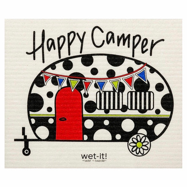 ivory colored rectangle shaped scrubbing pad with a vintage shaped camper in bold polka dot pattern in black and white colors with a red door and multicolored banner draping across camper front screen printed on it